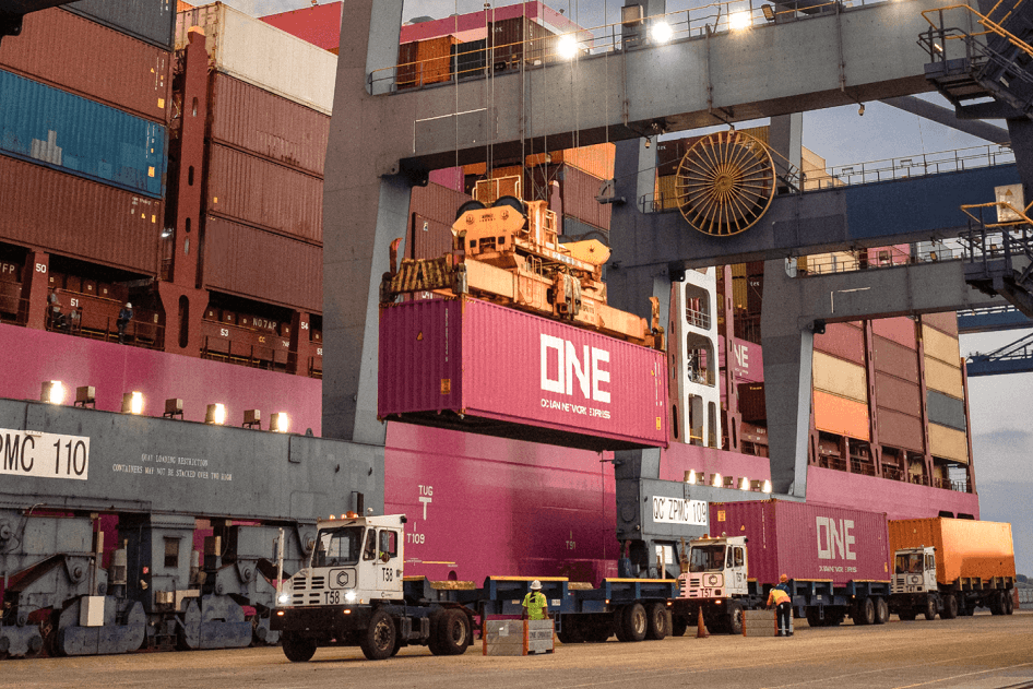ONE shipping container being lifted by a port crane onto an ocean vessel