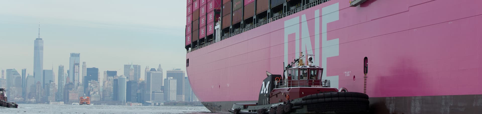 Tugboat guiding ONE container vessel to harbour
